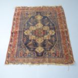A red-ground Bokhara rug. 136x116cm. Heavily worn all-over, particularly central lozenge. Fringed