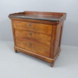 A continental mahogany and marble-topped chest of three long drawers, with raised back on turned