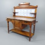 A Victorian mahogany marble topped wash stand, with raised tiled back and drawer and cupboard under.