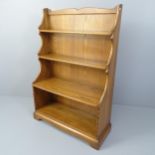 An Ercol mid-century elm waterfall open bookcase, with maker's label. 89x128x33cm.