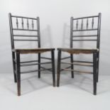 A pair of Morris & Company Arts & Crafts spindle back ebonised Sussex chairs with rush seats.