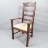 An Arts & Crafts oak ladder back armchair with heart and circle cut-outs.
