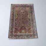 A Persian cream-ground silk prayer rug. 122x77cm.