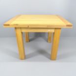 A modern light oak draw-leaf dining table. 110 (extending to 190) x79x90cm.