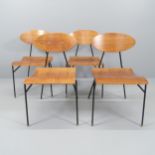 A set of four mid-century teak bent-ply chairs, with iron rod frames and brass capped feet