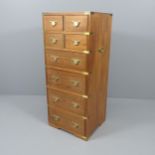 A teak and brass-bound campaign style chest of four short and four long drawers,. 46x108x41cm.
