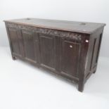 A 19th century panelled oak coffer, with chip carved decoration and raised on stile legs.
