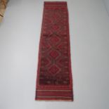 A red-ground Meshwani runner. 242x57cm. Good condition.