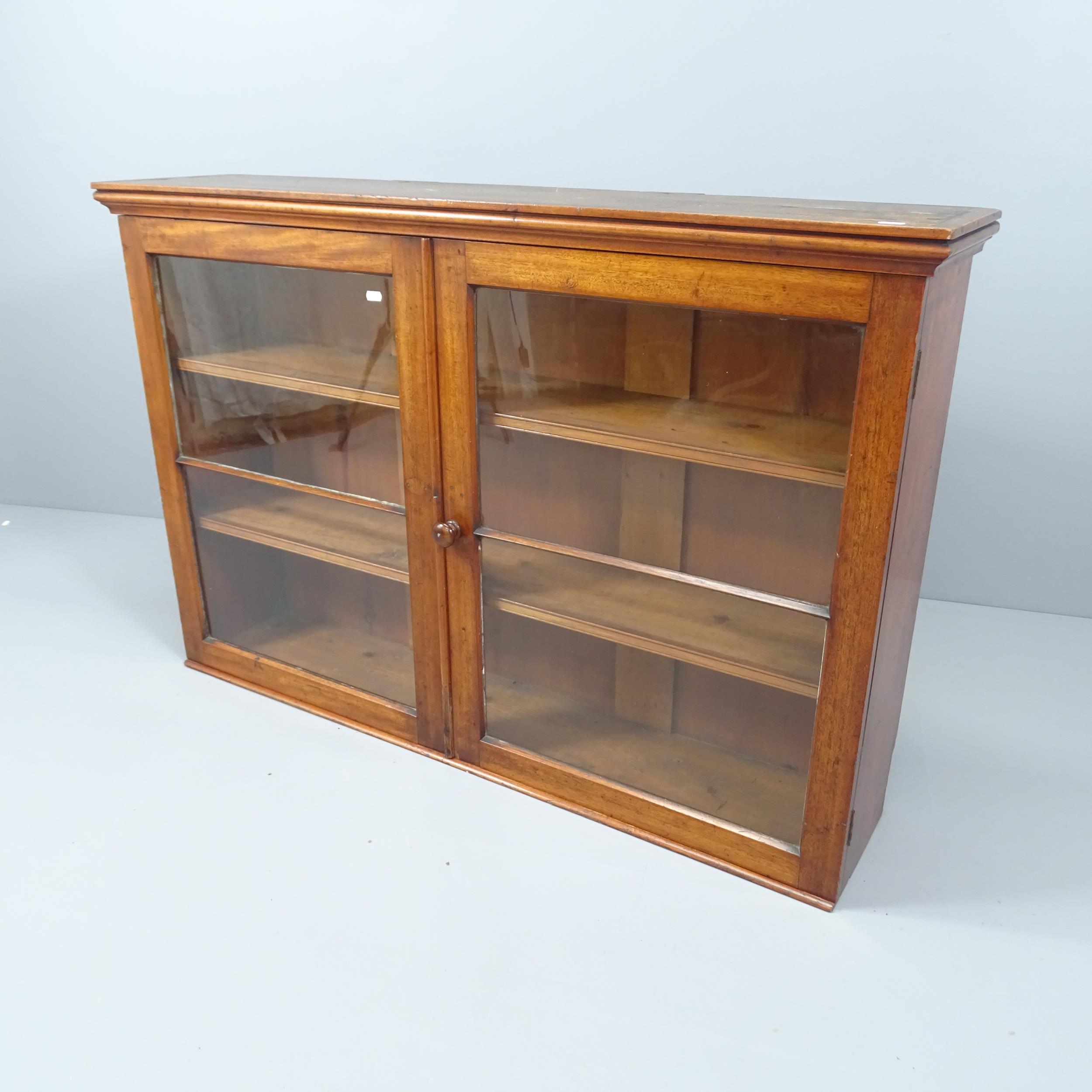 An antique mahogany bookcase, with two glazed doors and two fixed shelves. 127x84x28cm