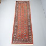 An orange-ground Afghan runner. 245x83cm Generally good used condition, though signs of wear all