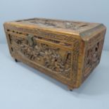 A Chinese camphorwood blanket box, with all-over carved decoration. 89x48x44cm.