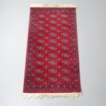 A Belgian made modern red-ground machine made Afghan design wool runner. 157x85cm. Good condition.