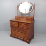 An Edwardian crossbanded mahogany and satinwood strung dressing chest, with fitted oval mirror.