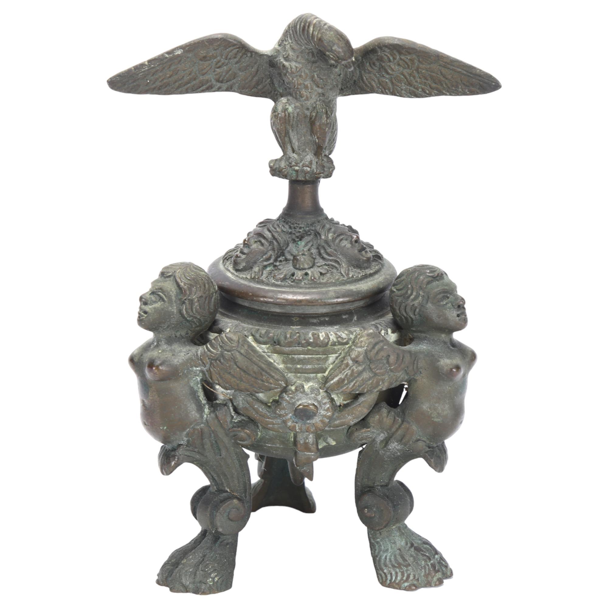 A Napoleon III style patinated bronze inkwell, of Baroque design, with winged monopodia lion paw