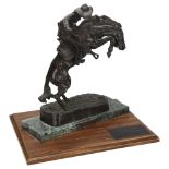 A 20th century bronze sculpture "The Bronco Buster" by Frederic Remington, signed to base, on marble