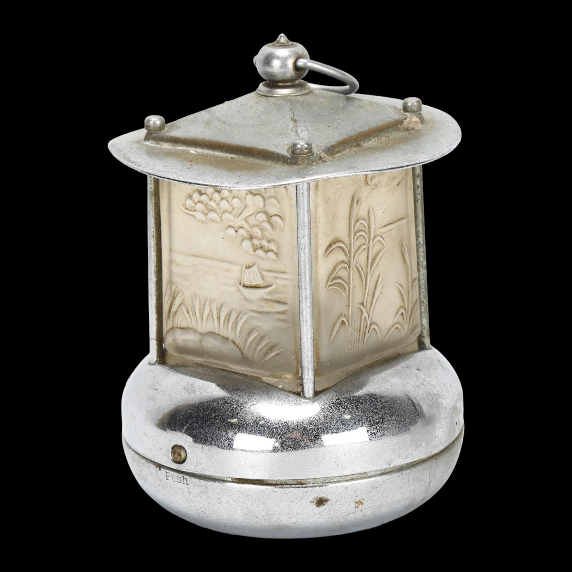 An Art Deco Pifco novelty miniature nickel plated night lamp, with relief moulded glass apertures,