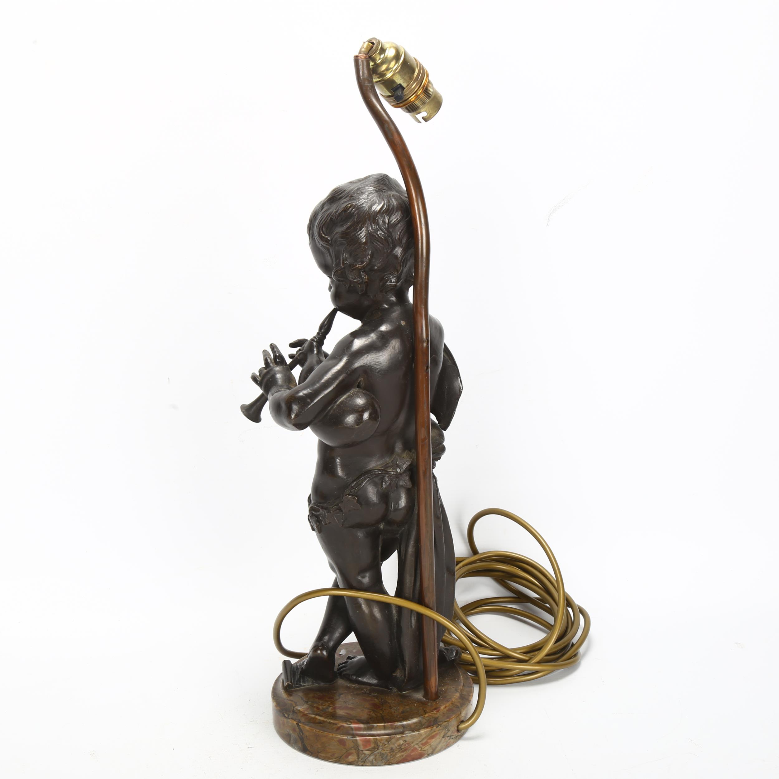 An Antique bronze cherub sculpture playing pipes, on marble base with lamp fitting, bronze height - Image 2 of 3