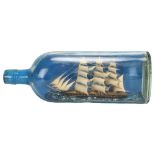 A handmade ship in a bottle, length 30cm Glass has fungus marks otherwise no damage