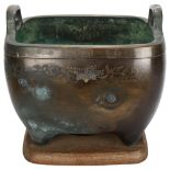 A large Chinese bronze planter, with engraved decoration and silver inlay Greek key border, on