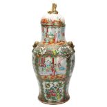 A Chinese Canton famille rose vase and cover, with hand painted and enamelled figures in courtyard