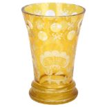A 19th century Bohemian amber-flashed glass spa beaker, with etched stag and bridge decoration,