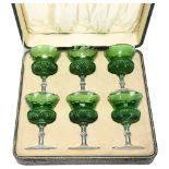A cased set of 6 green cut crystal thistle wine glasses, with etched thistle decoration All