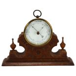 A brass-cased aneroid barometer, maker's mark SJL & Co, on fitted Gothic oak base, width 22cm