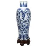 A large Chinese blue and white baluster vase with floral decoration, on wooden stand, height of vase