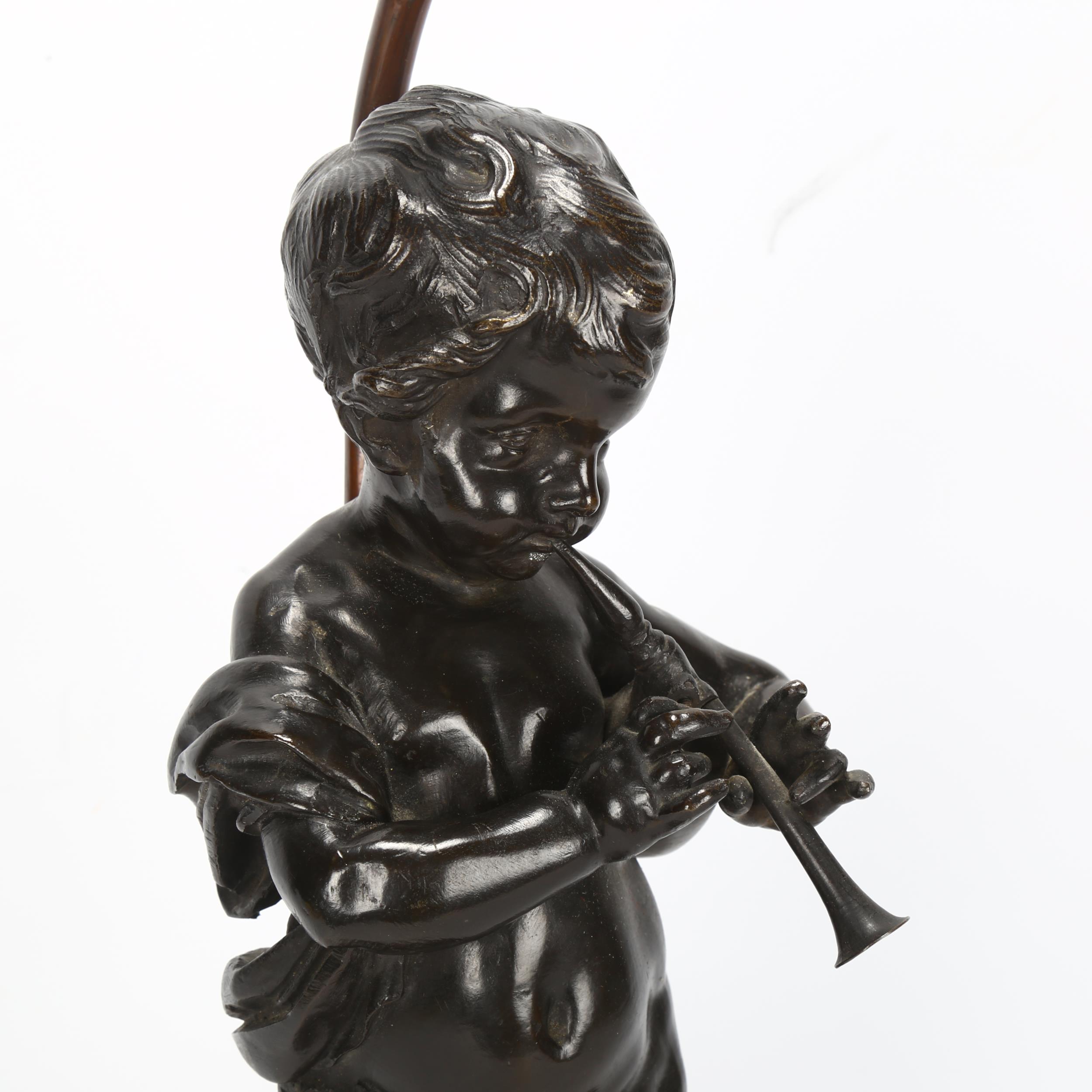 An Antique bronze cherub sculpture playing pipes, on marble base with lamp fitting, bronze height - Image 3 of 3