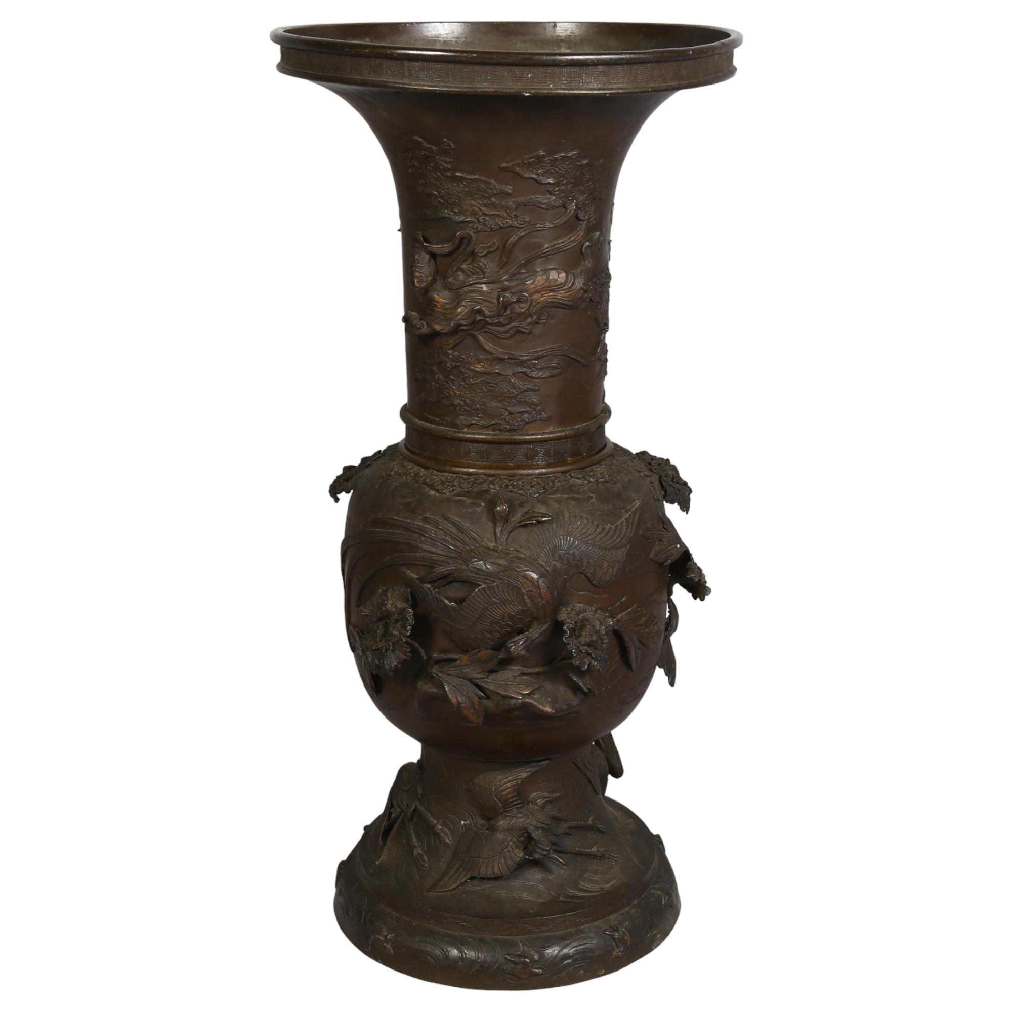 An Antique Chinese large cast-bronze vase in 2 sections, with birds and plants in high relief,