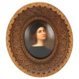 A 20th century miniature portrait on porcelain plaque, after Raphael's self-portrait, in carved wood