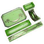 An Art Deco silver overlaid green glass desk set, comprising paperweight, pen tray, desk blotter,