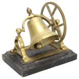 A novelty cast-brass desk bell, on ebonised base, width 18cm General wear to high points, no