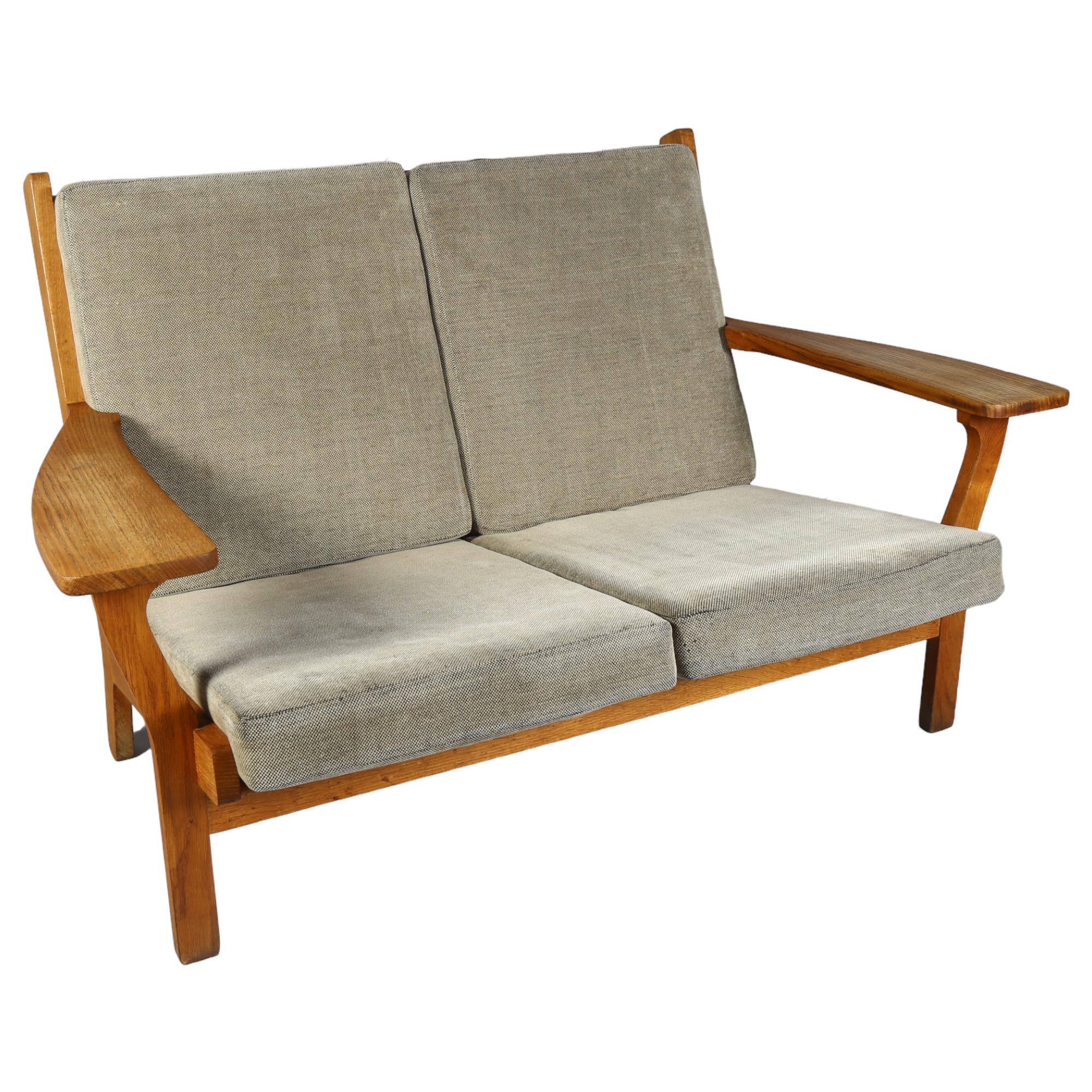 Hans Wegner, a mid-century Danish 2-seater sofa, model GE 330/2 by Getama, the oak frame with