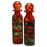 Two orange Mdina glass decanters and stoppers with blue trailed decoration, both signed Mdina,