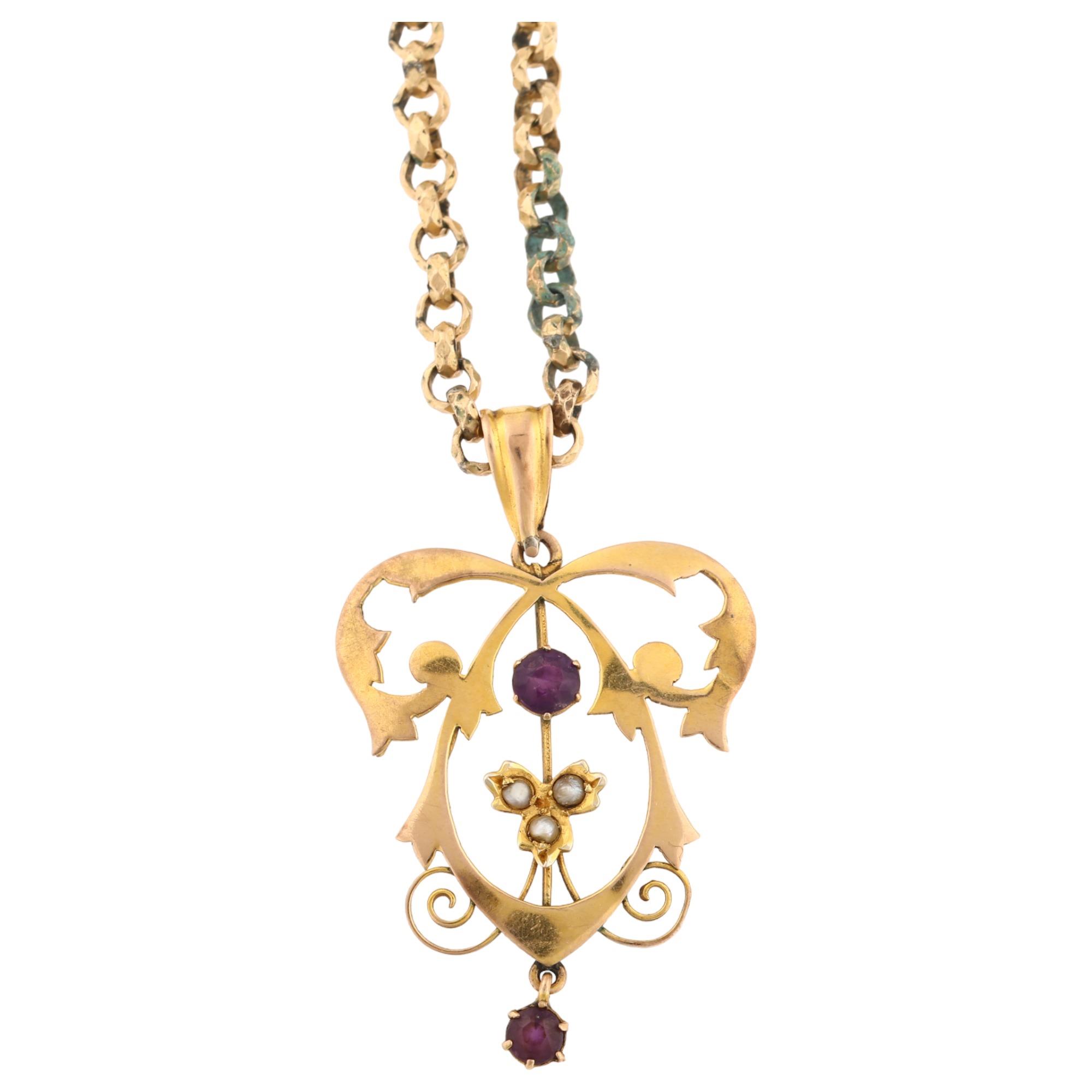 An Edwardian Art Nouveau 9ct gold amethyst and pearl openwork pendant necklace, on gold plated