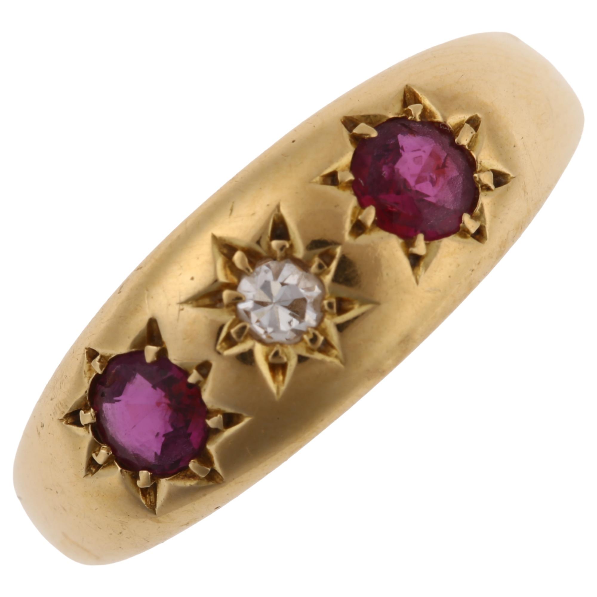 An early 20th century 18ct gold three stone ruby and diamond gypsy ring, set with round-cut ruby and