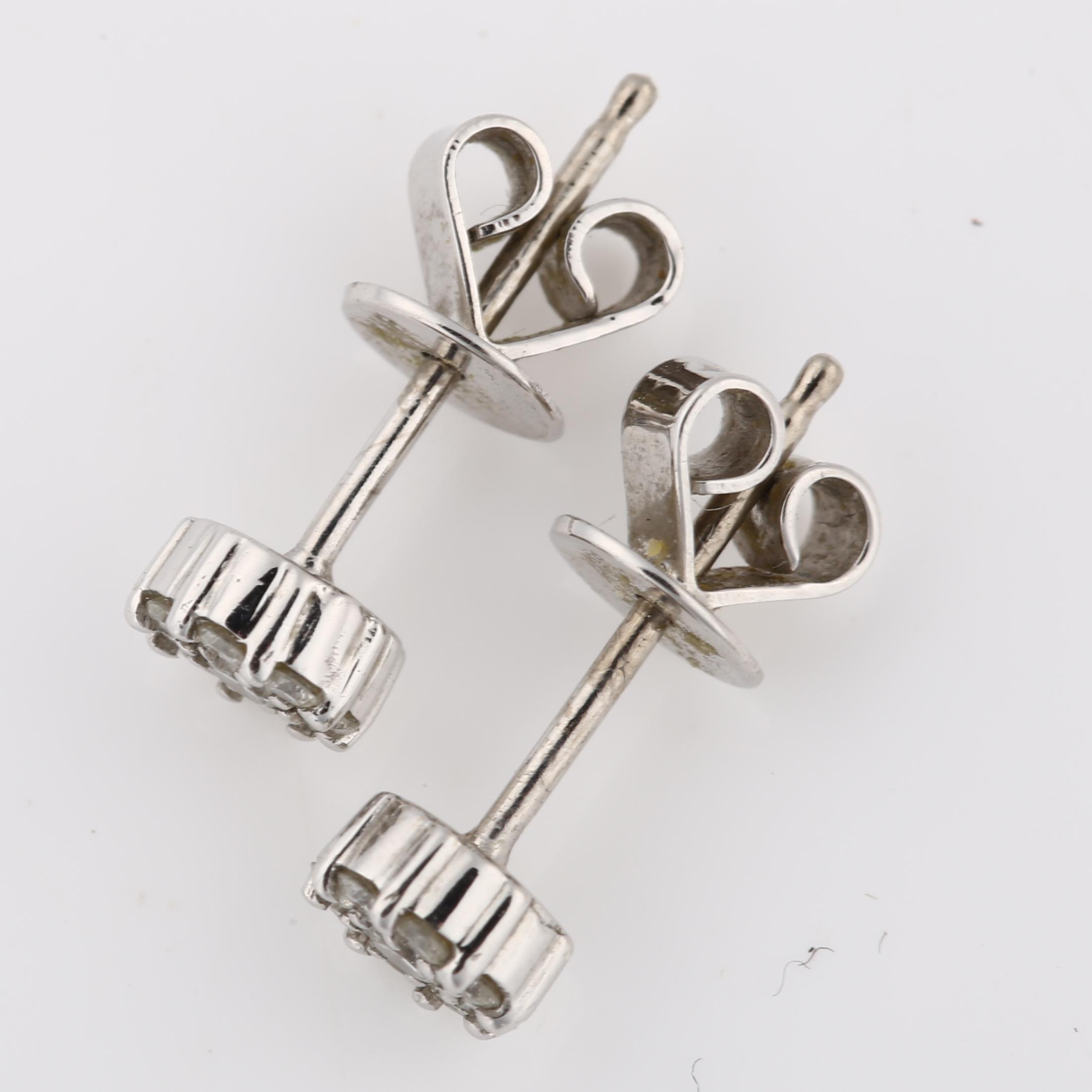 A pair of 18ct white gold diamond cluster earrings, set with modern round brilliant-cut diamonds and - Image 3 of 4