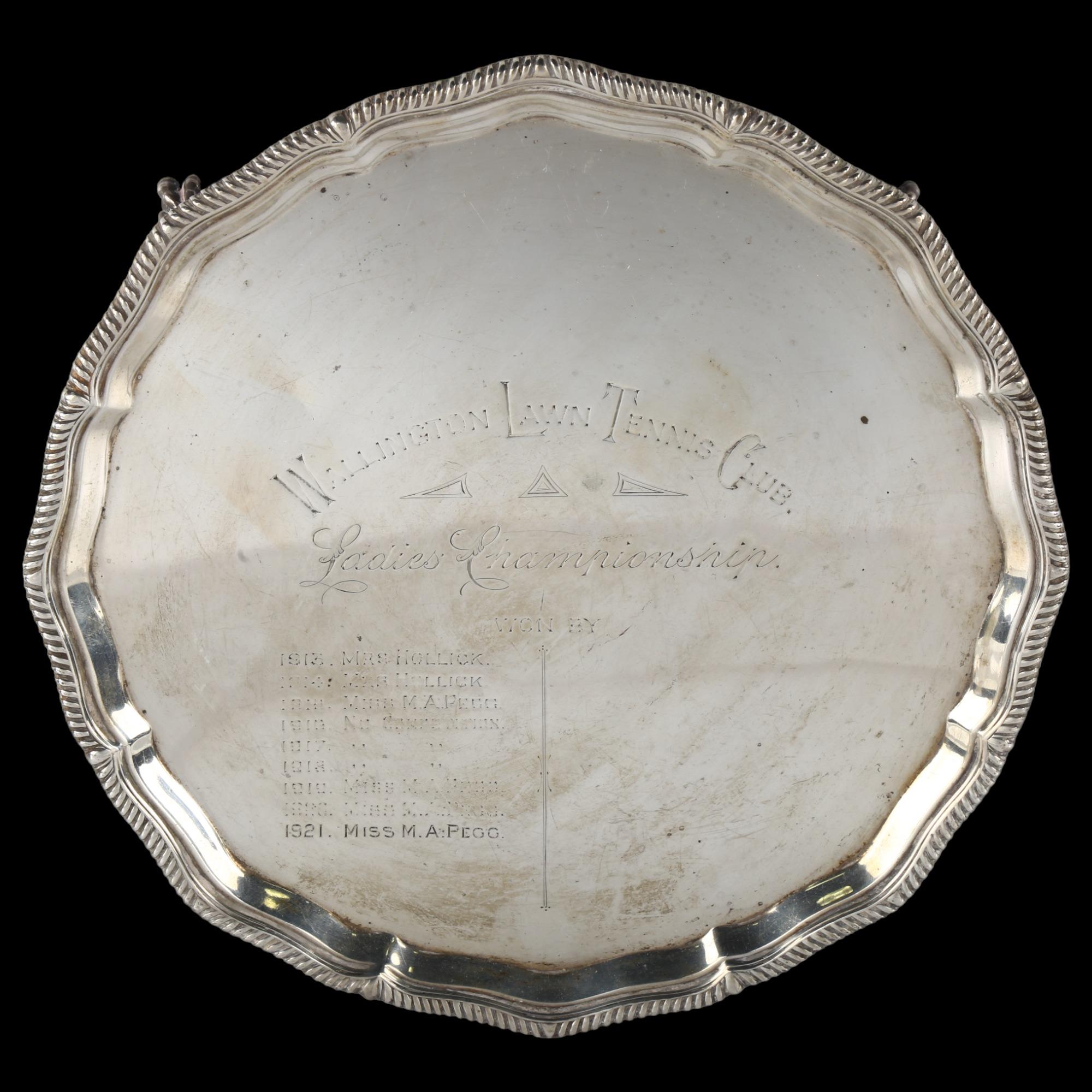 A George V silver presentation salver, circular form with scalloped and gadrooned rim, on claw and