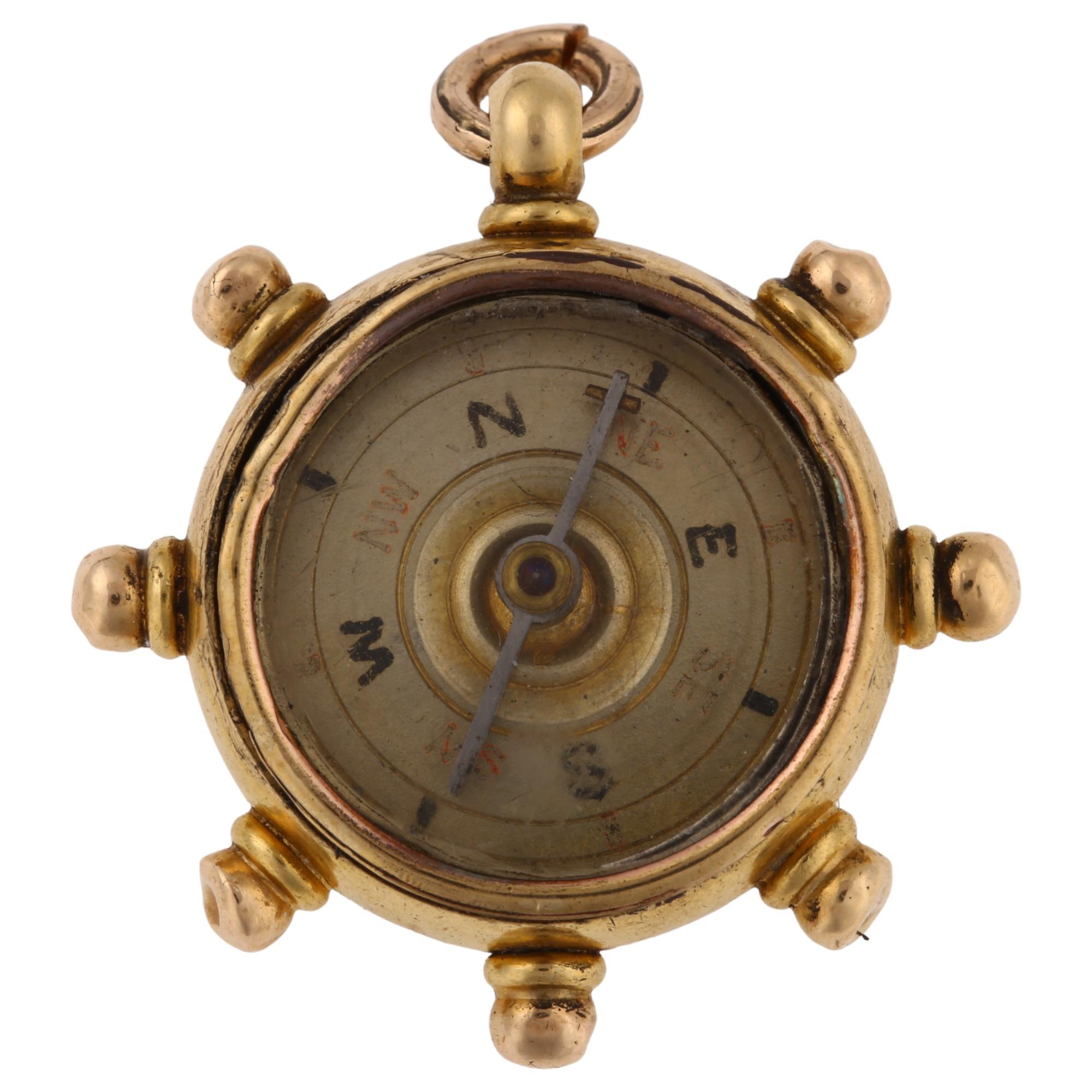 A late Victorian 18ct gold carnelian ship's wheel compass fob, maker's marks B and S, hallmarks