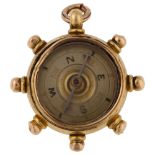 A late Victorian 18ct gold carnelian ship's wheel compass fob, maker's marks B and S, hallmarks