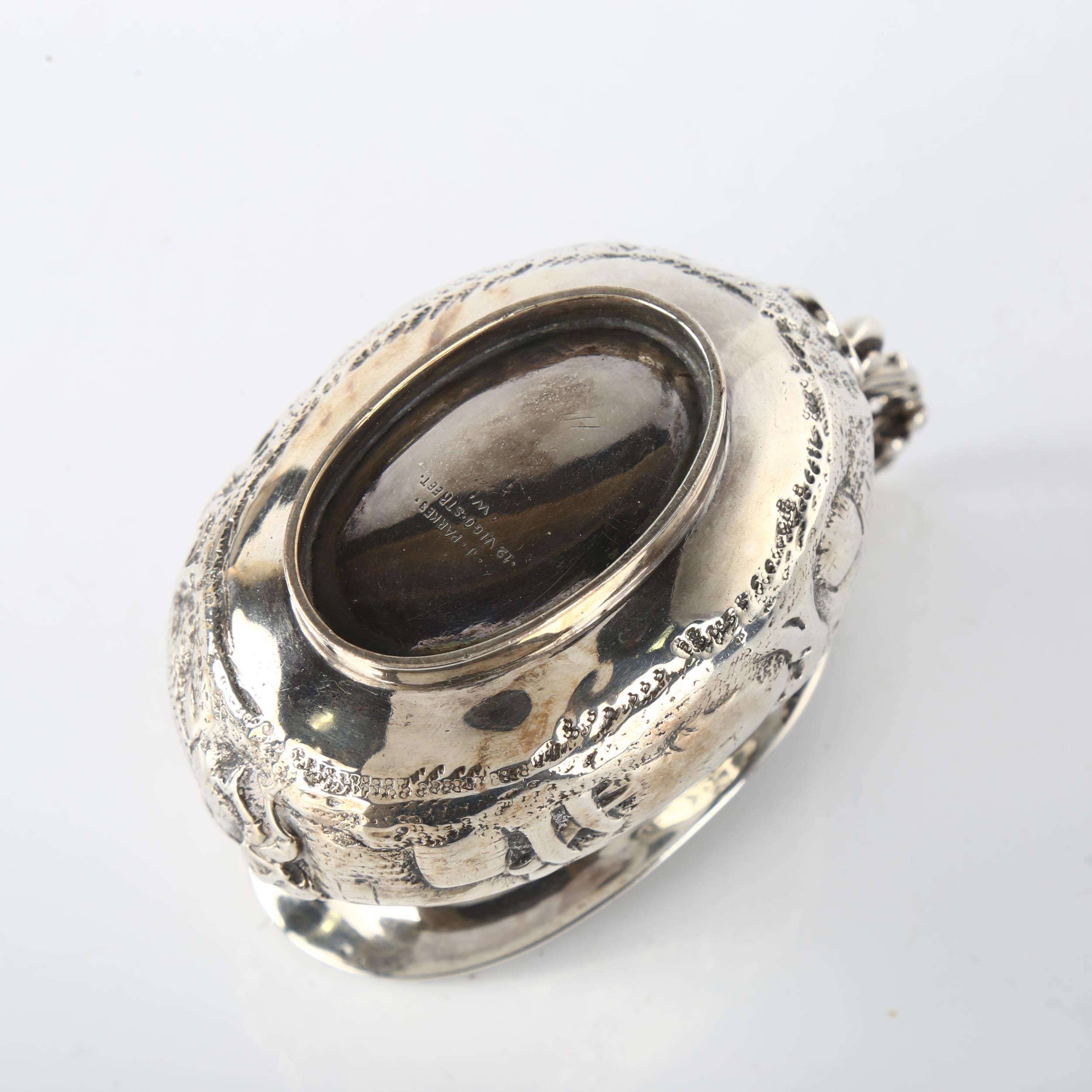 A Victorian silver cream jug, oval bulbous form with relief embossed village decoration and - Image 3 of 3