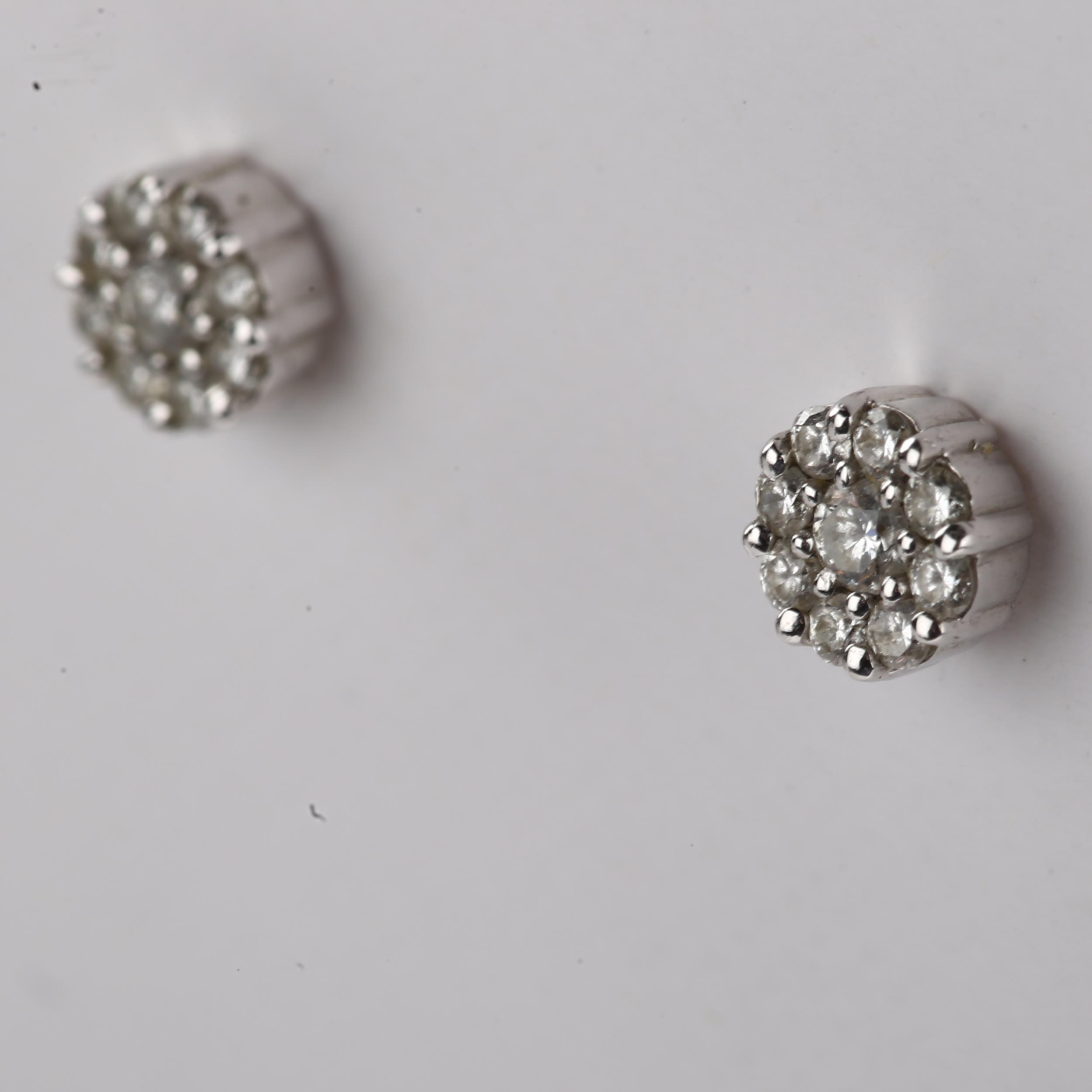 A pair of 18ct white gold diamond cluster earrings, set with modern round brilliant-cut diamonds and - Image 2 of 4