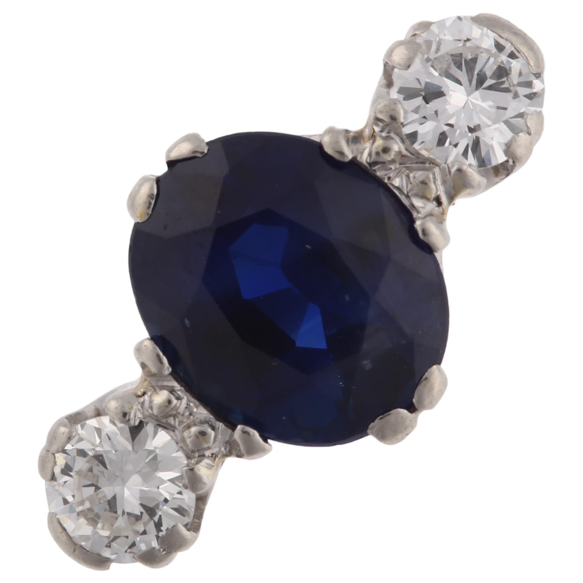 A late 20th century 18ct white gold three stone sapphire and diamond ring, platinum-topped set