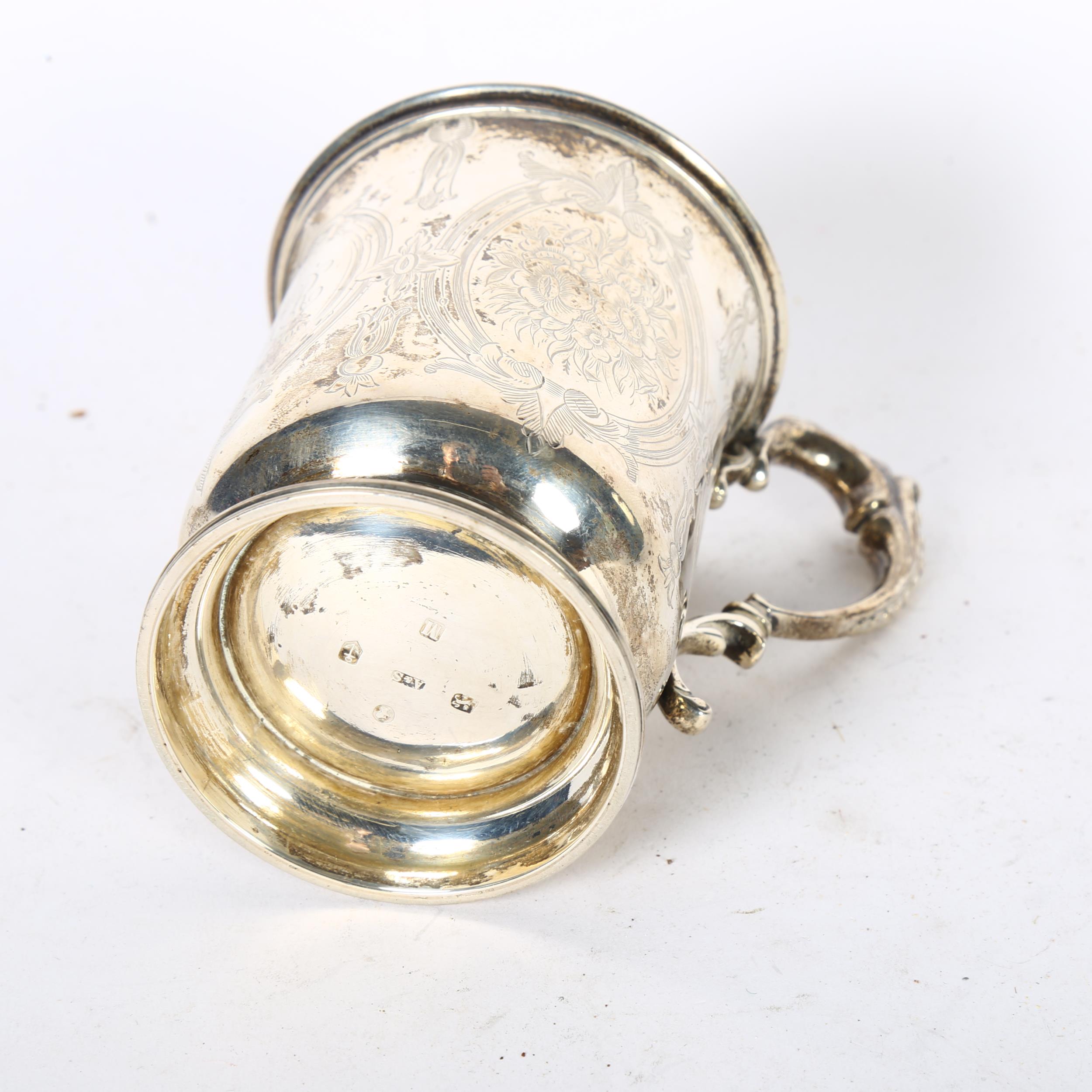 An ornate Victorian silver tankard on turned foot, with engraved decoration, with monogram HHR and - Image 2 of 2