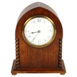 An Edwardian oak lancet-top mantel clock, with French movement and enamel dial, H20cm Good overall