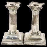 A pair of George V silver Corinthian column candlesticks, on stepped plinth bases, H15cm,