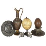 A Persian brass ewer, with snake handle and knop, a Scrimshaw carved ostrich egg on stand,