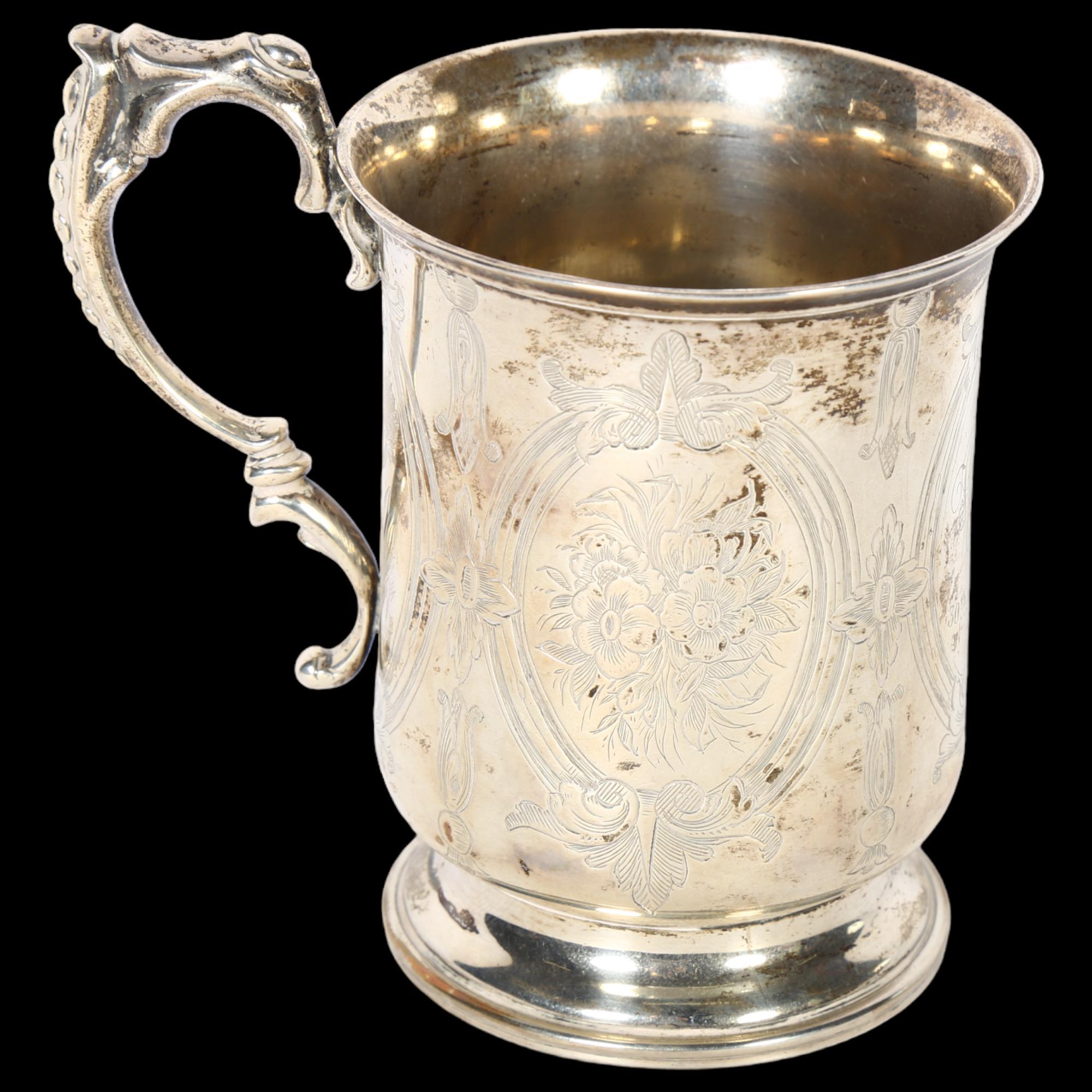 An ornate Victorian silver tankard on turned foot, with engraved decoration, with monogram HHR and