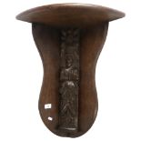 An Antique carved oak figural panel, L55cm, mounted into a later oak corner bracket, overall